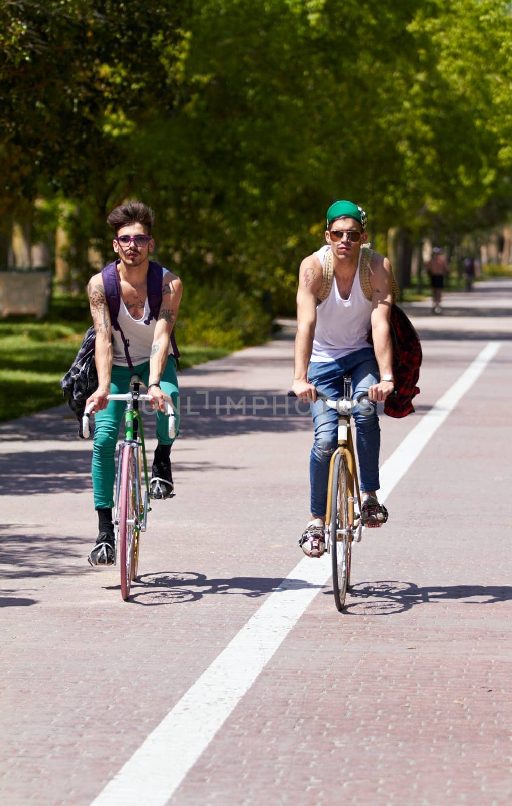 Bicycle, travel and men friends in a city street riding, bond and enjoying freedom on holiday or vacation together. Cycling, bike and people in a road with freedom, adventure and neighborhood hangout.