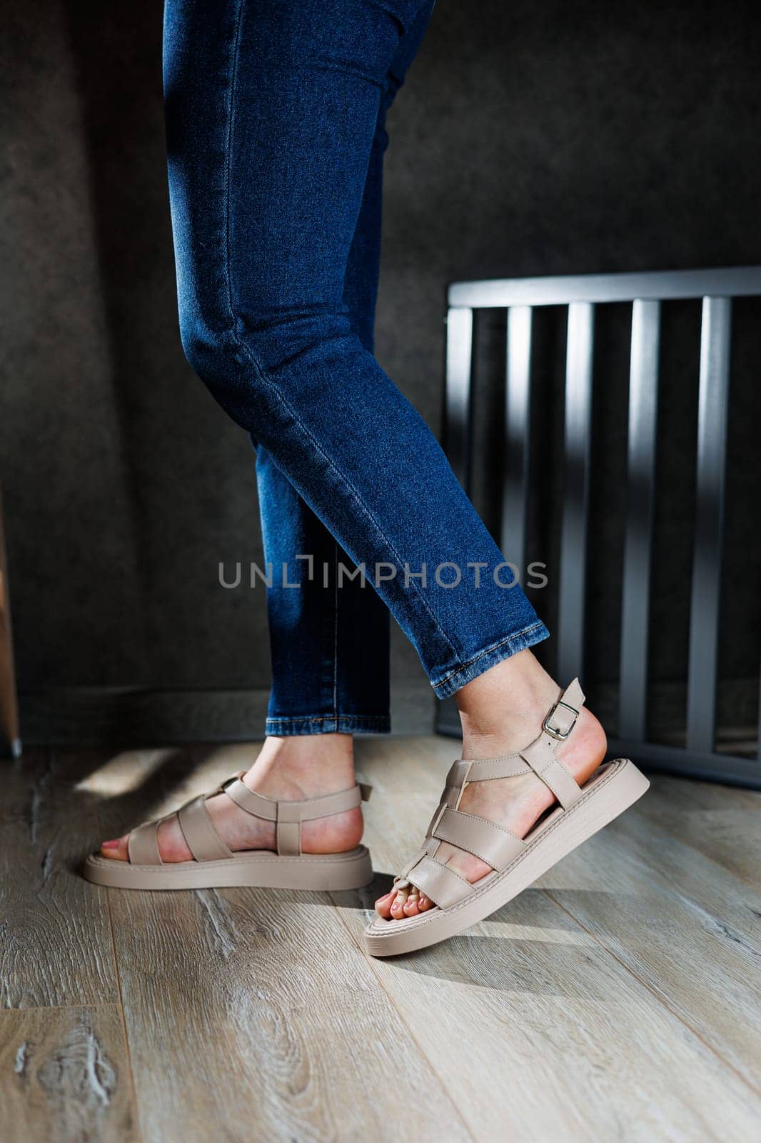 Collection of women's leather summer sandals. Slender female legs in beige leather sandals without heels. by Dmitrytph