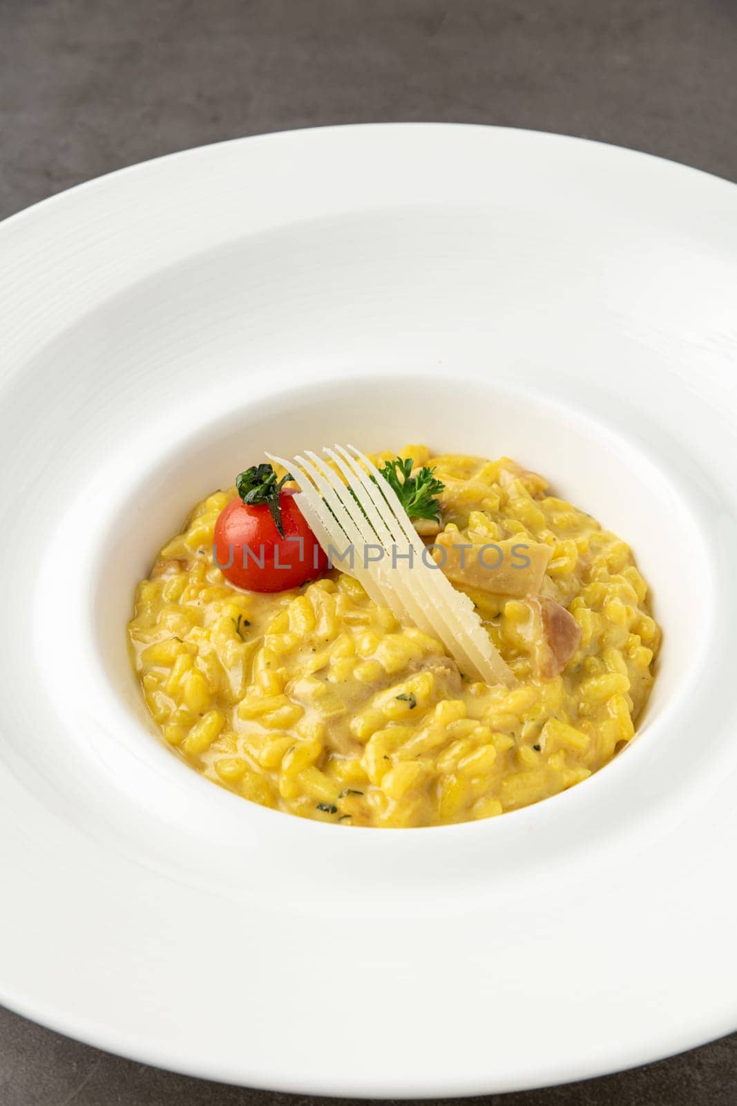 Parmesan cheese risotto on a white porcelain plate by Sonat