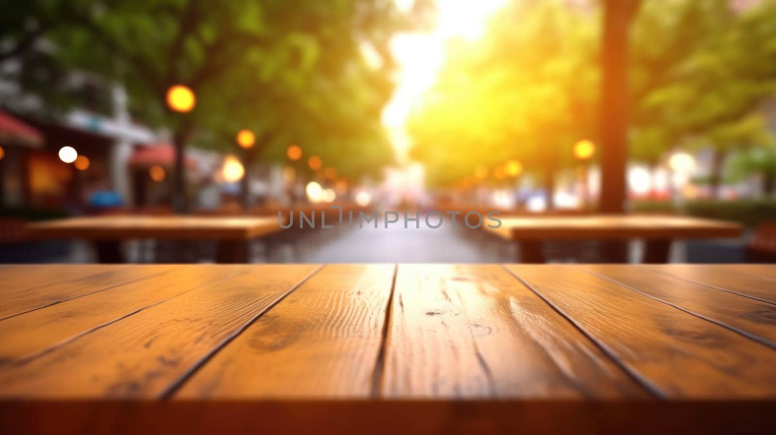 The empty wooden table top with blur background of outdoor cafe in the morning. Exuberant image.