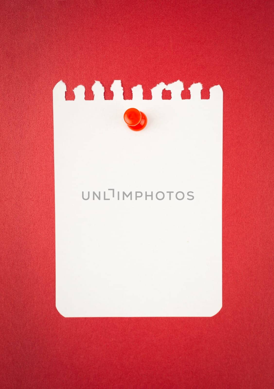 The Blank white torn paper note with push pin on red background. by Gamjai