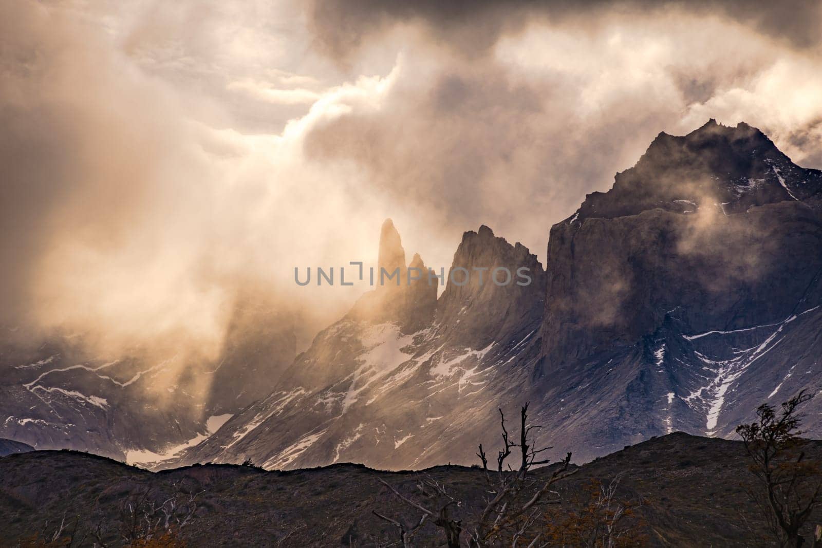 Mystic light mood backlit at Torres del Paine National Park with clouds and mountains, Chile