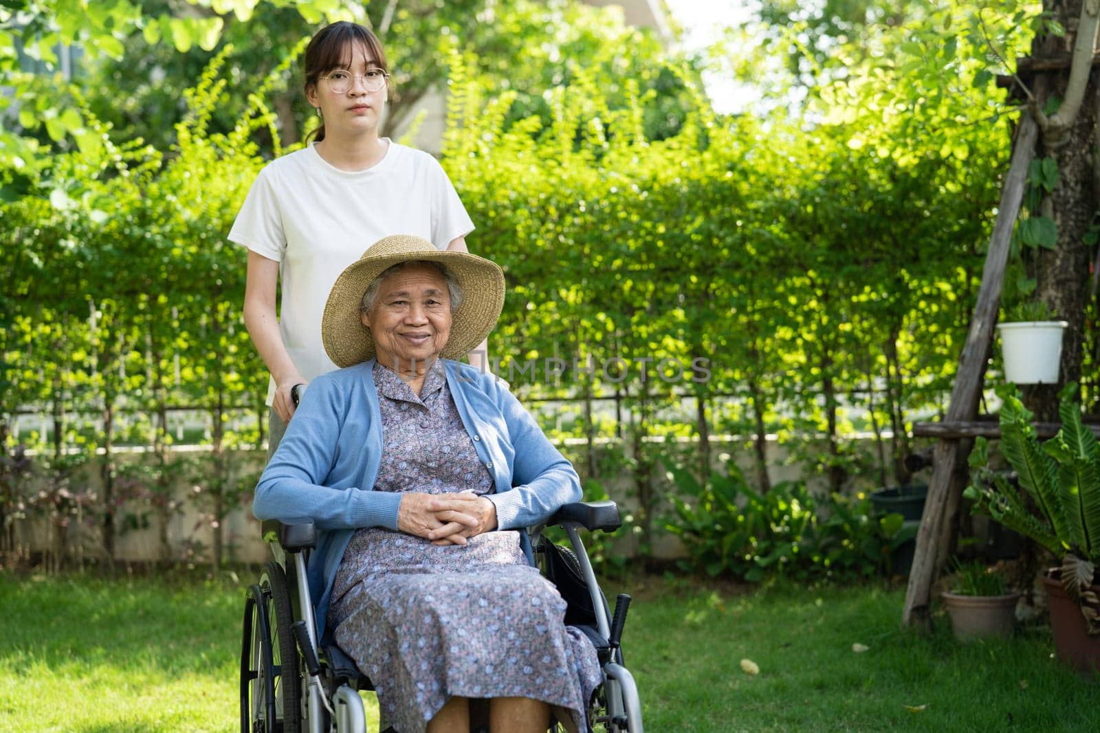 caregiver help and care Asian senior woman patient sitting on wheelchair at nursing hospital ward, healthy strong medical concept. by pamai