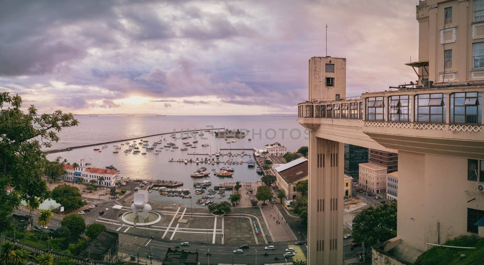 Enjoy the vintage air of the famous LaCerda Elevator, the first elevator in the world, as you admire a panoramic view of Salvador de Bah�a at sunset with a cloud-covered sky over the sea.