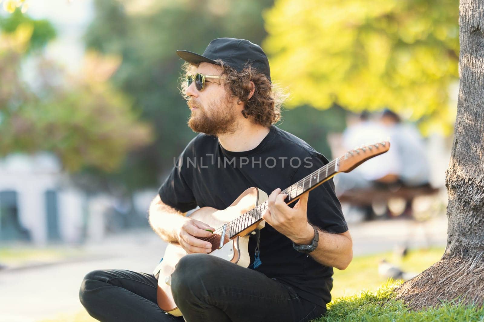 Man playing electric guitar on the street. Mid shot