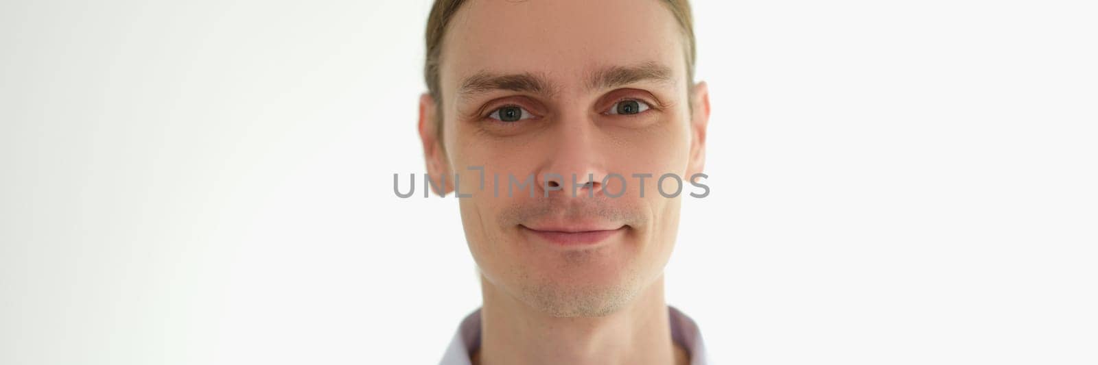 Portrait of young man in shirt on white background. Success in business concept