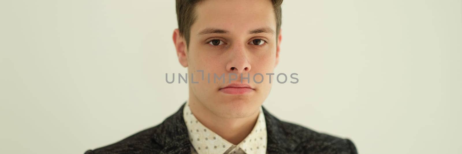 Portrait of young handsome businessman in suit with tie on white background. Career in business concept