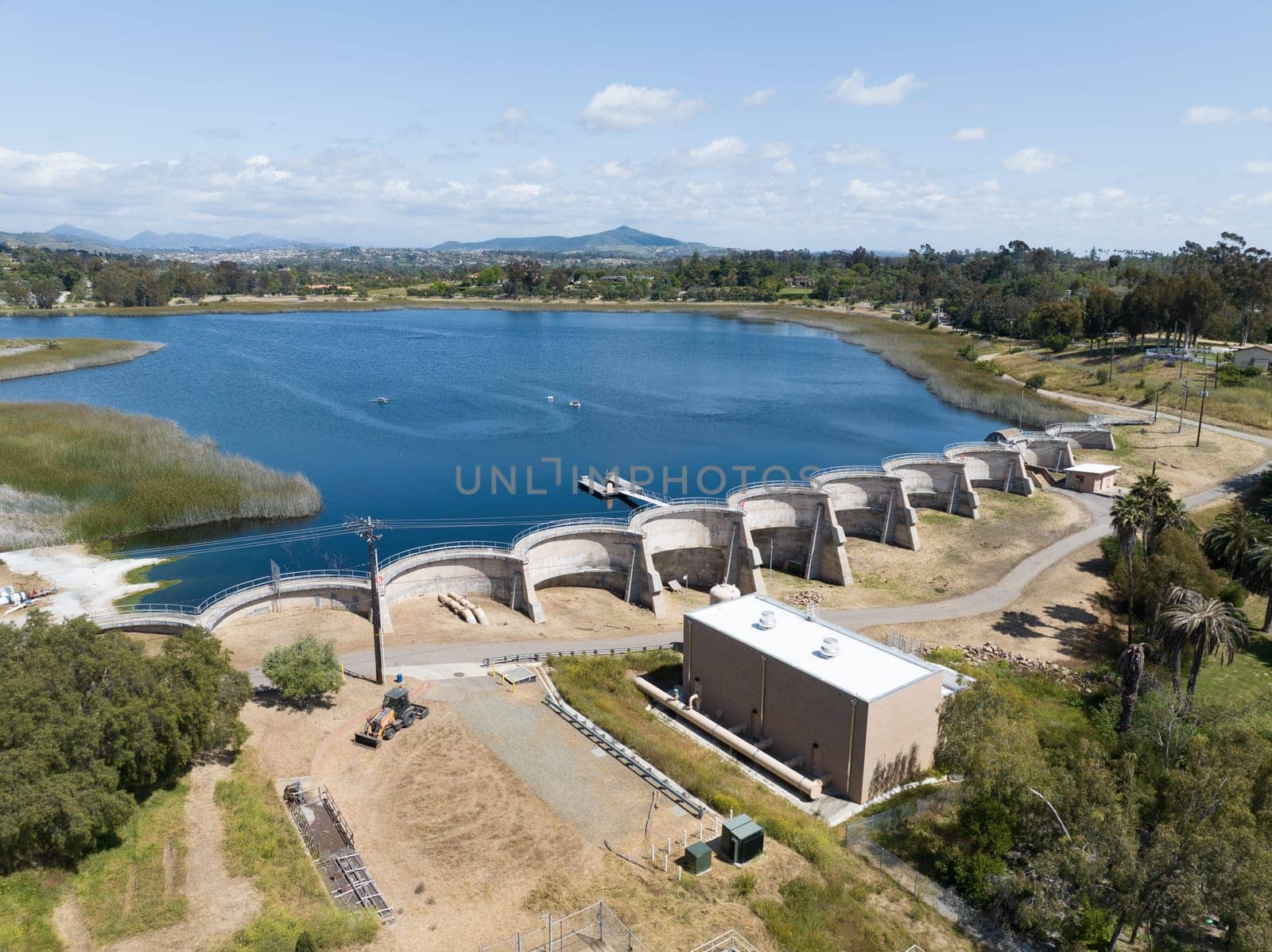 Aerial view over water reservoir and a large dam that holds water. Rancho Santa Fe in San Diego, California, USA