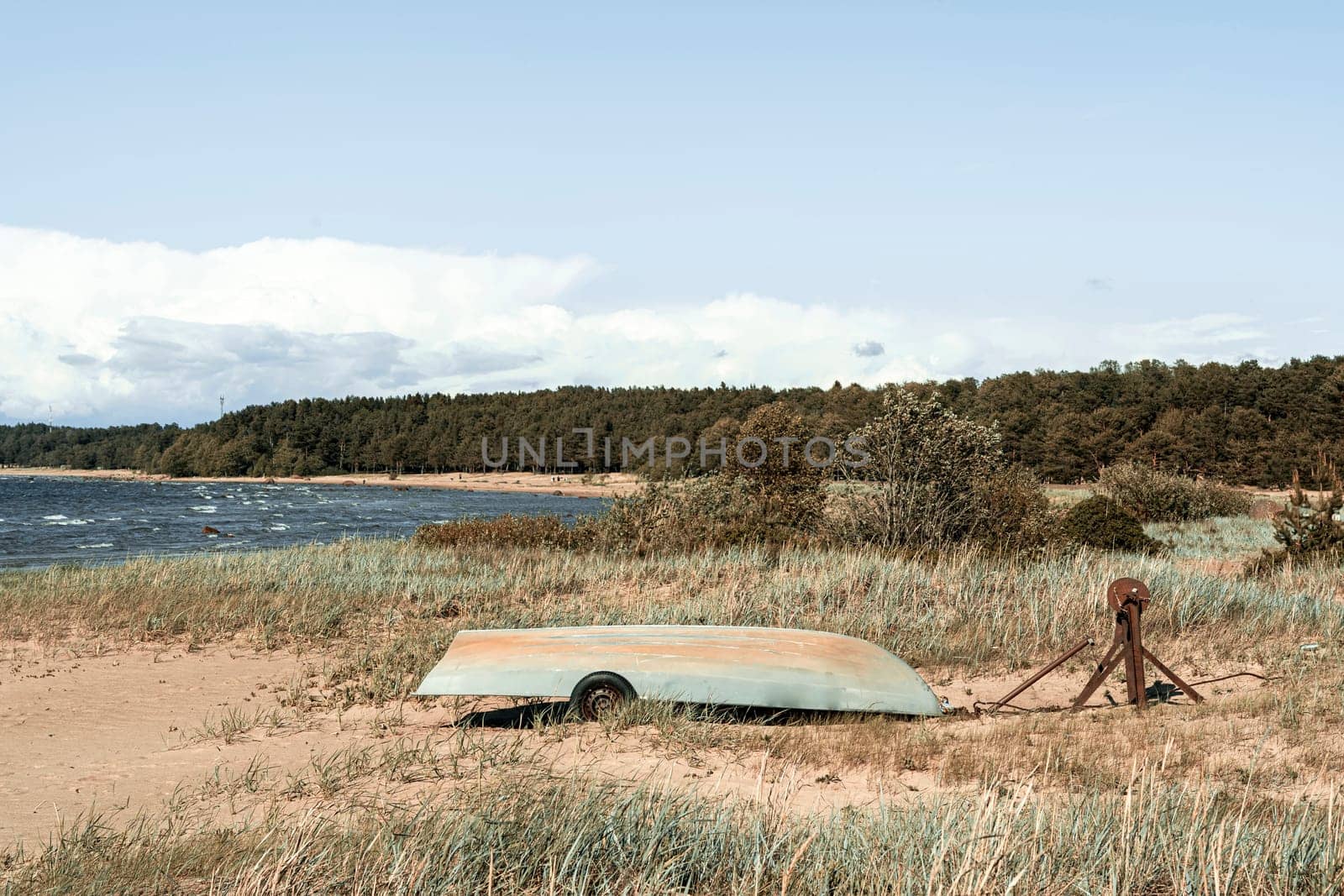 Old fishing boats pulled out on the sandy shore of the sea bay by audiznam2609