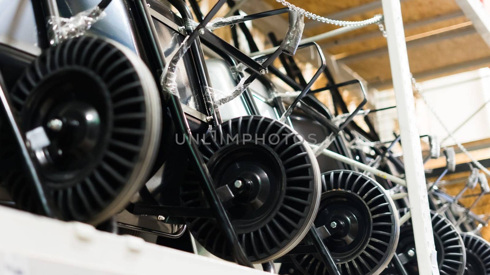 A lot of New varios color Garden wheelbarrow cart on a hardware store, gardening tools