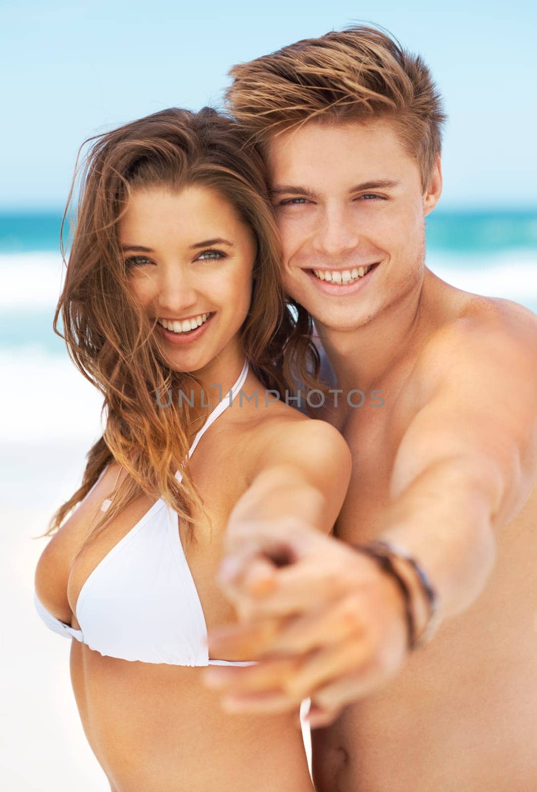 Portrait, holiday and couple holding hands on a beach, date or travel for tropical summer vacation at the ocean. Happy, people and smile together with happiness and freedom to relax in Australia.