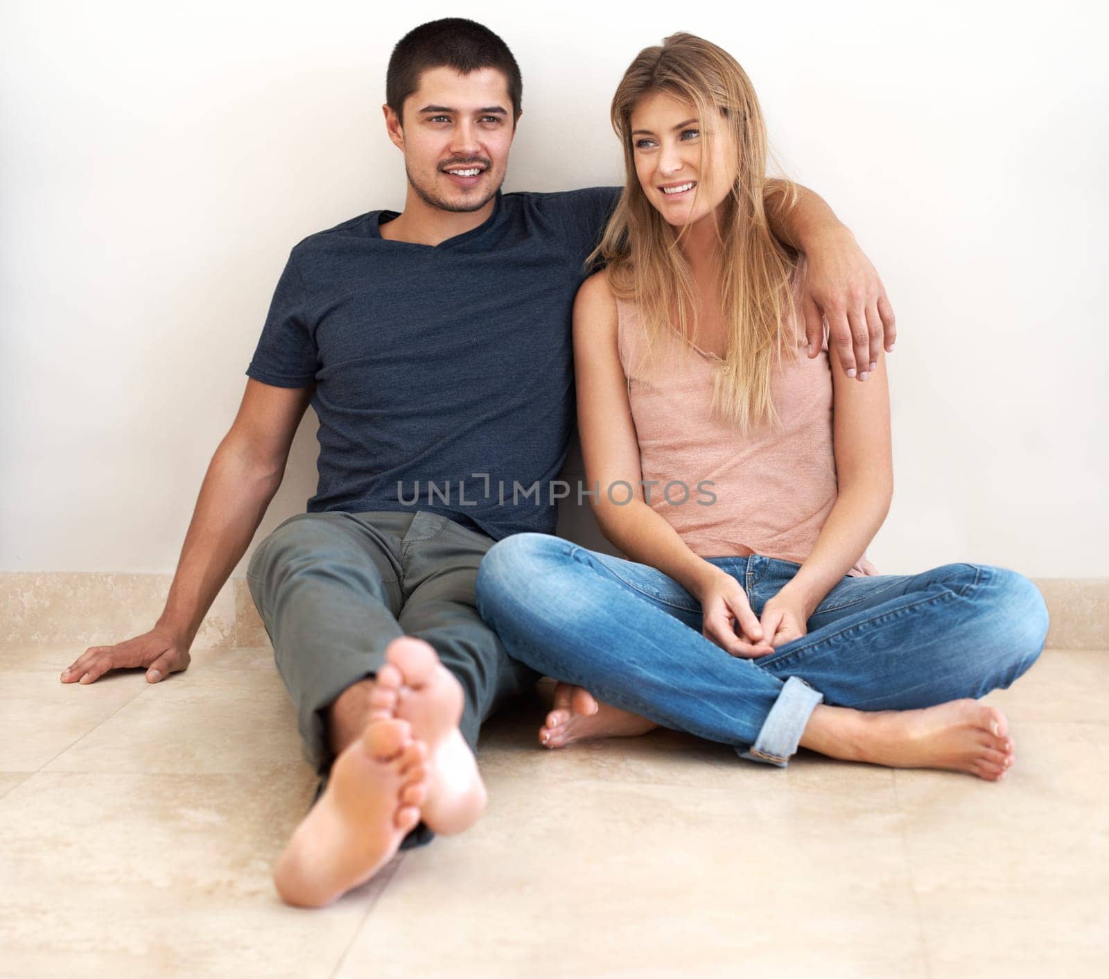 Hug, relax and couple on the floor of their new house talking, bond and excited for real estate success. Property, moving and man and woman sitting on living room ground together in their dream home.