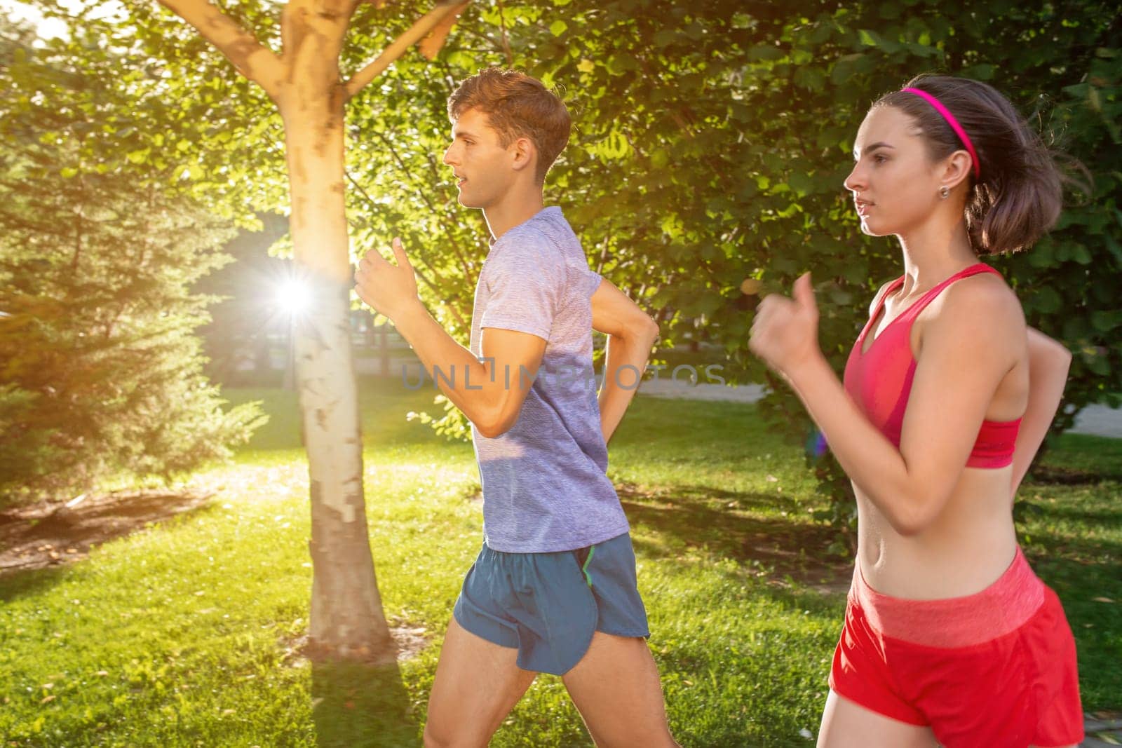 Portrait of cheerful caucasian couple running outdoors by nazarovsergey