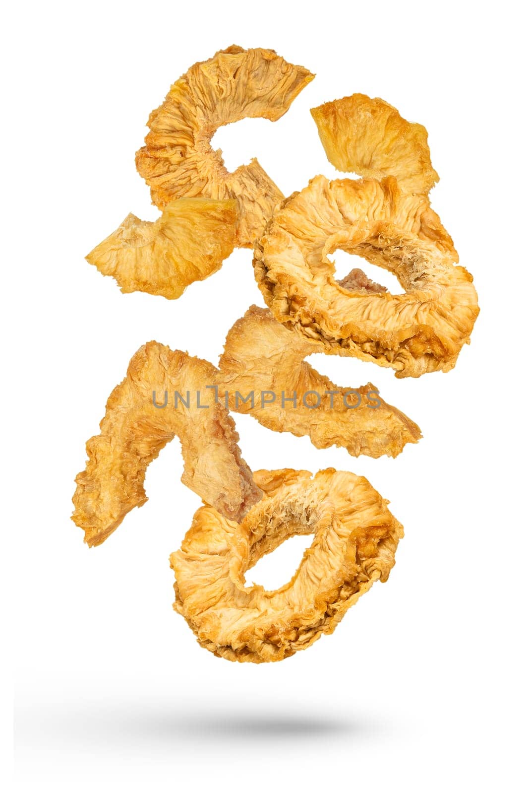 Falling slices of dried pineapple on a white isolated background. Dried pineapple rings of different cuts scatter in different directions. High quality photo. by SERSOL