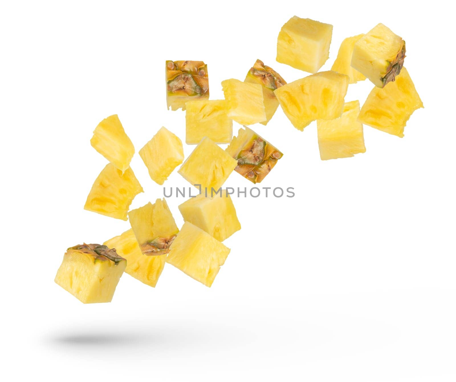 Pieces of pineapple on a white isolated background. Juicy pieces of pineapple with the remnants of the peel scatter in different directions. Isolate of flying pieces of pineapple. by SERSOL