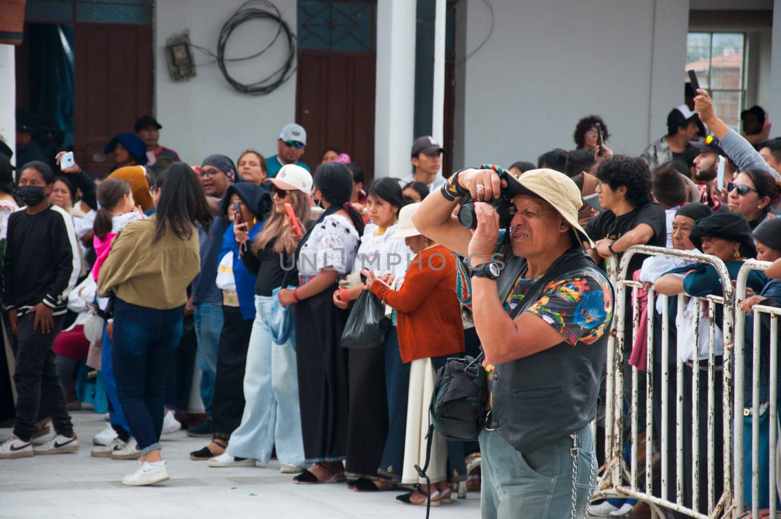 Otavalo, Ecuador - 24 de junio de 2023: photographer taking photos in an act of the inti raymi of Ecuador. High quality photo