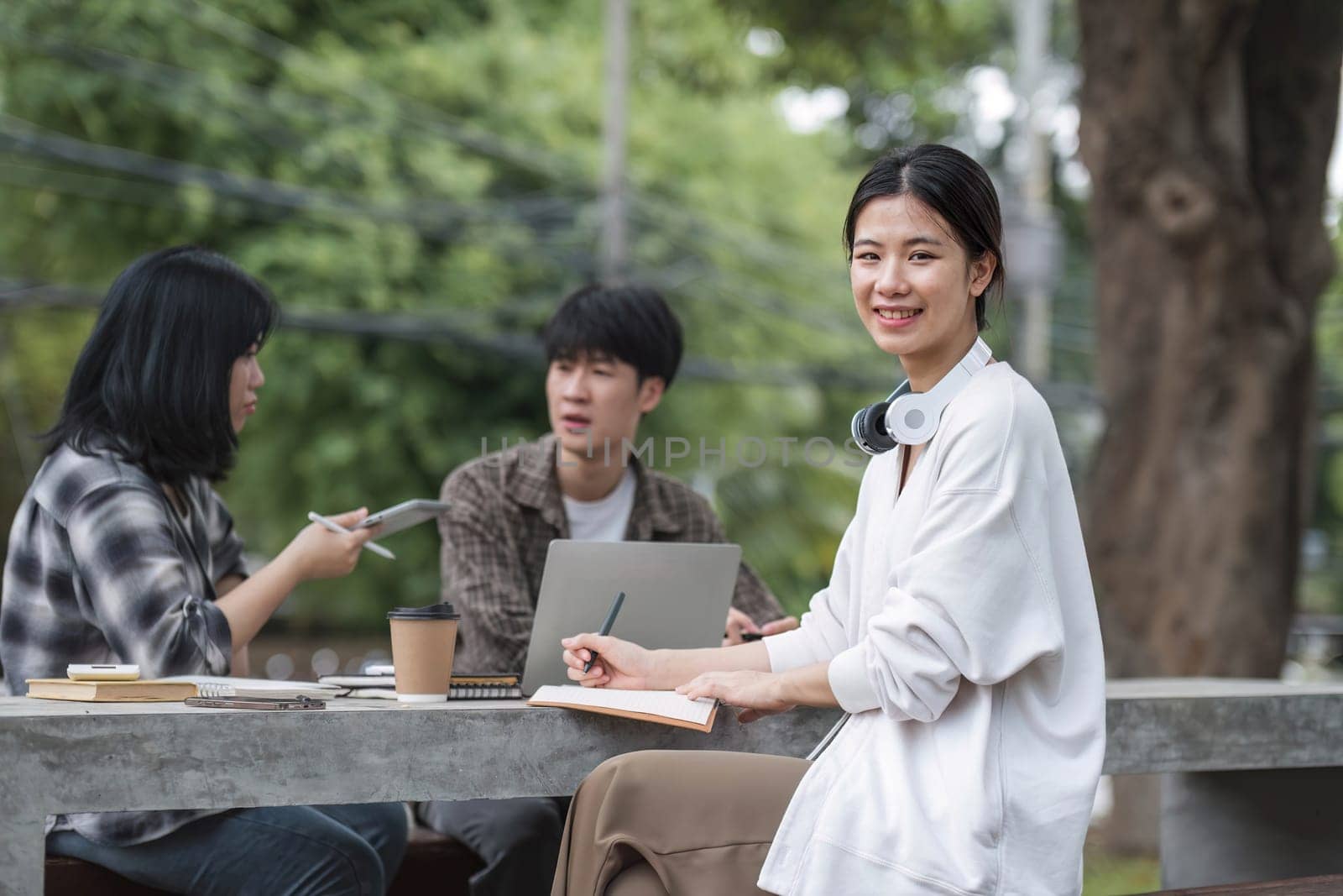 Students asian portrait together smiling group reading book study with laptop at university high school campus,college in summer holiday relaxation..