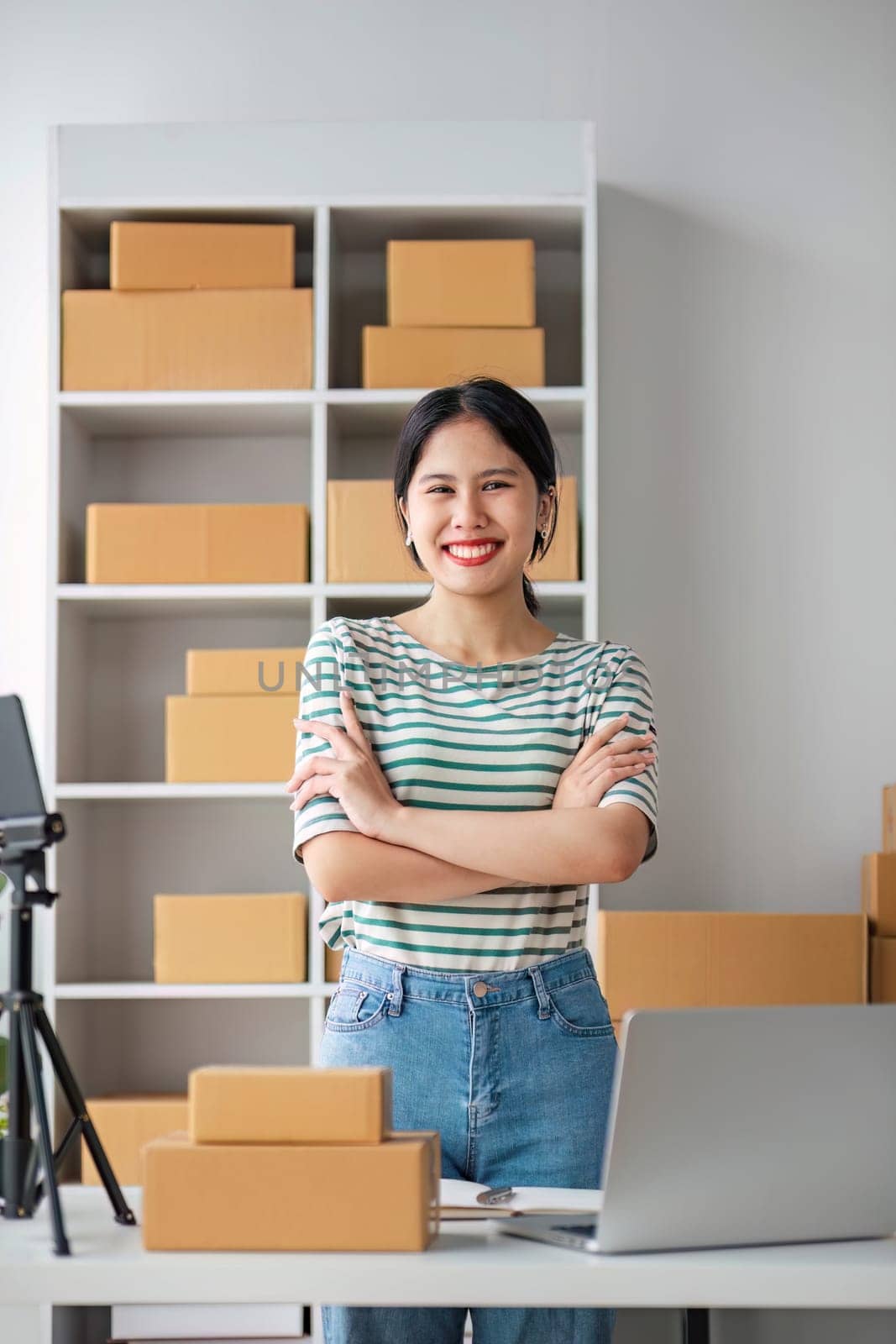 Starting Small business entrepreneur SME freelance, Portrait young woman working at home office, BOX, smartphone, laptop, online, marketing, packaging, delivery, b2b, SME, e-commerce concept.. by wichayada