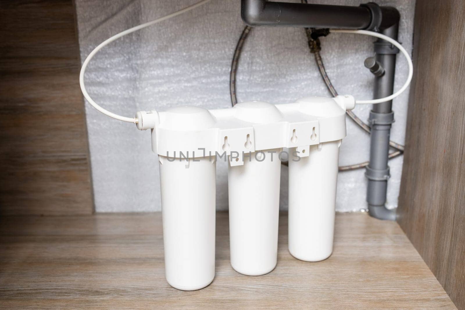 Installation of water purification filters under kitchen sink in cupboard by andreyz