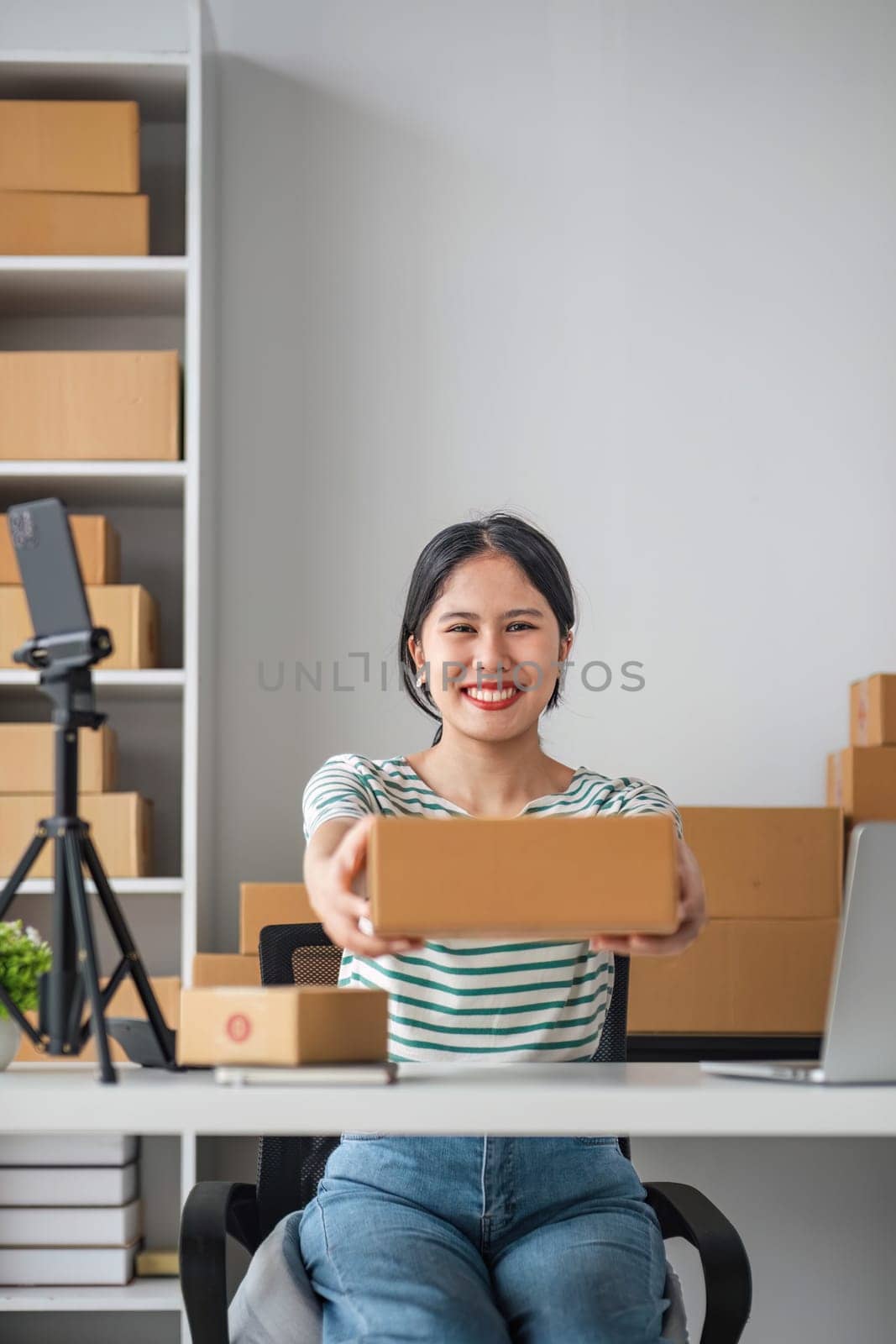 Starting Small business entrepreneur SME freelance, Portrait young woman working at home office, BOX, smartphone, laptop, online, marketing, packaging, delivery, b2b, SME, e-commerce concept.. by wichayada