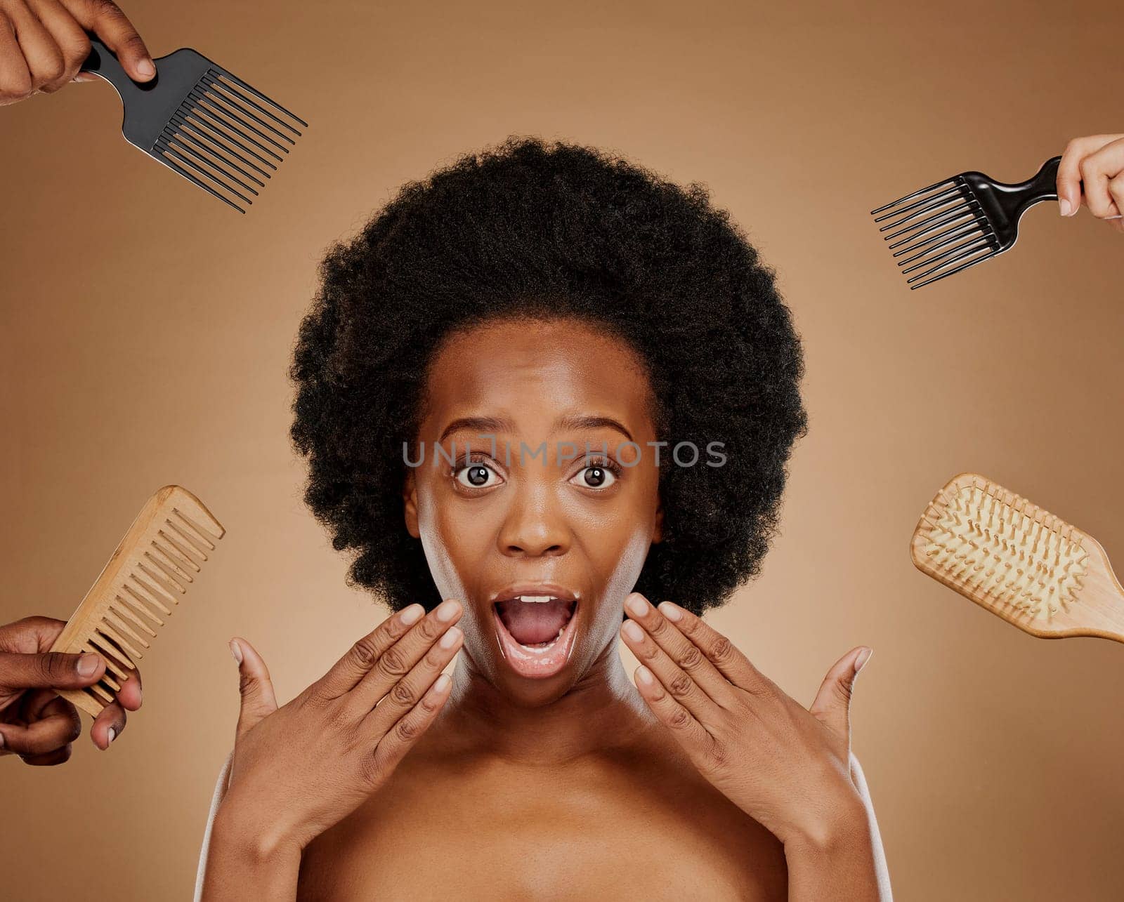 Portrait, wow and hands in a salon with a black woman in studio on a brown background for beauty or cosmetics. Face, afro and hair with a young female person looking surprised at natural care options by YuriArcurs