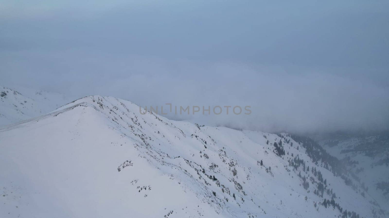 Mystical dawn with clouds in snowy mountains by Passcal