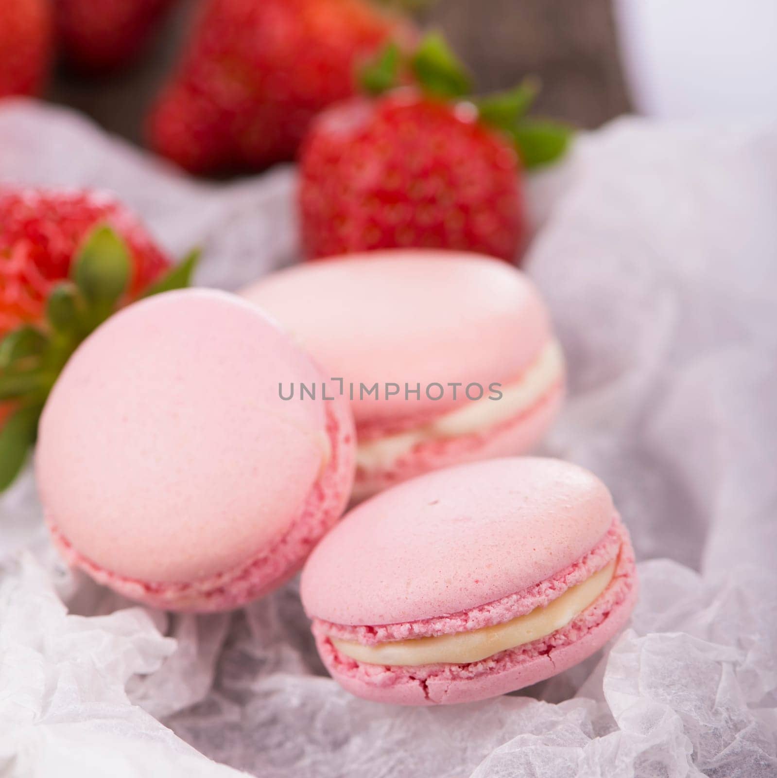 Macaroon with berries cookies on a wooden background