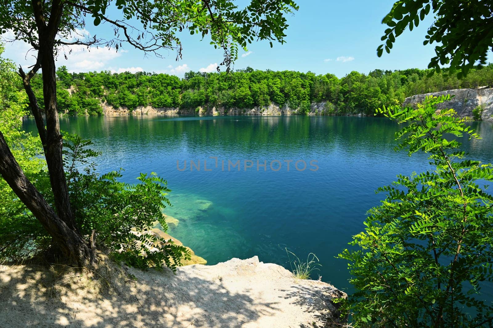 Beautiful flooded quarry with clear water for swimming. Summer landscape concept with nature. Masovice - Czech Republic. by Montypeter