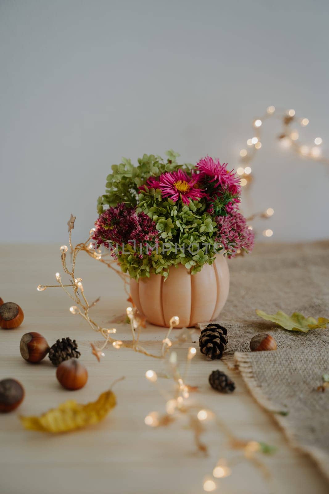 Happy Thanksgiving. Autumn bouquet in a decorative planter in the form of a pumpkin. by Rodnova