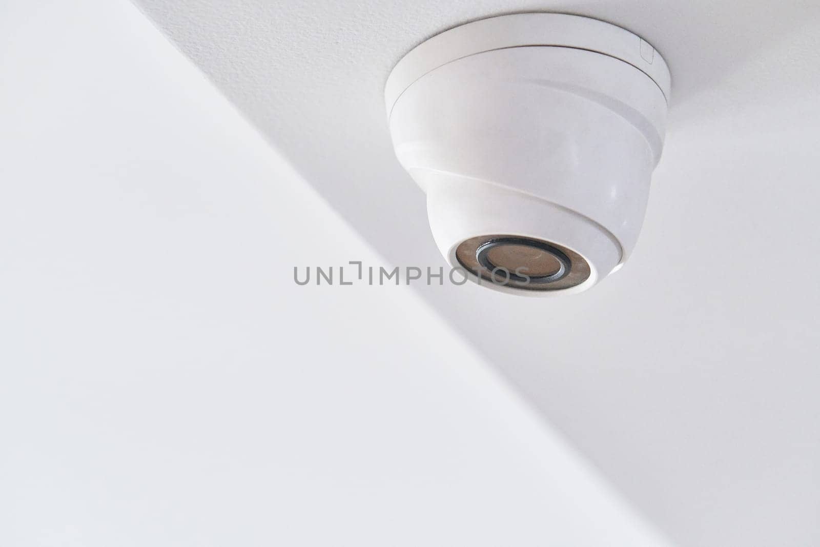 Cctv on white ceiling in modern building by snep_photo