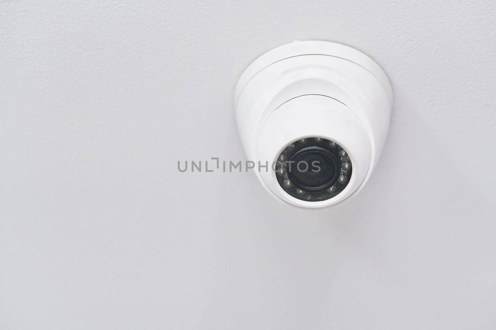 Cctv on white ceiling in modern building by snep_photo