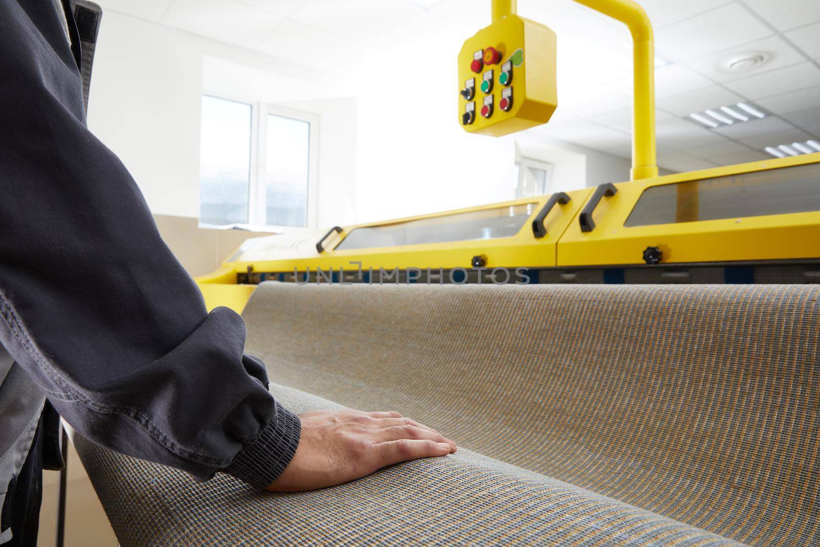 Man worker cleaning carpet on automatic washing machine equipment and dryer in the Laundry room