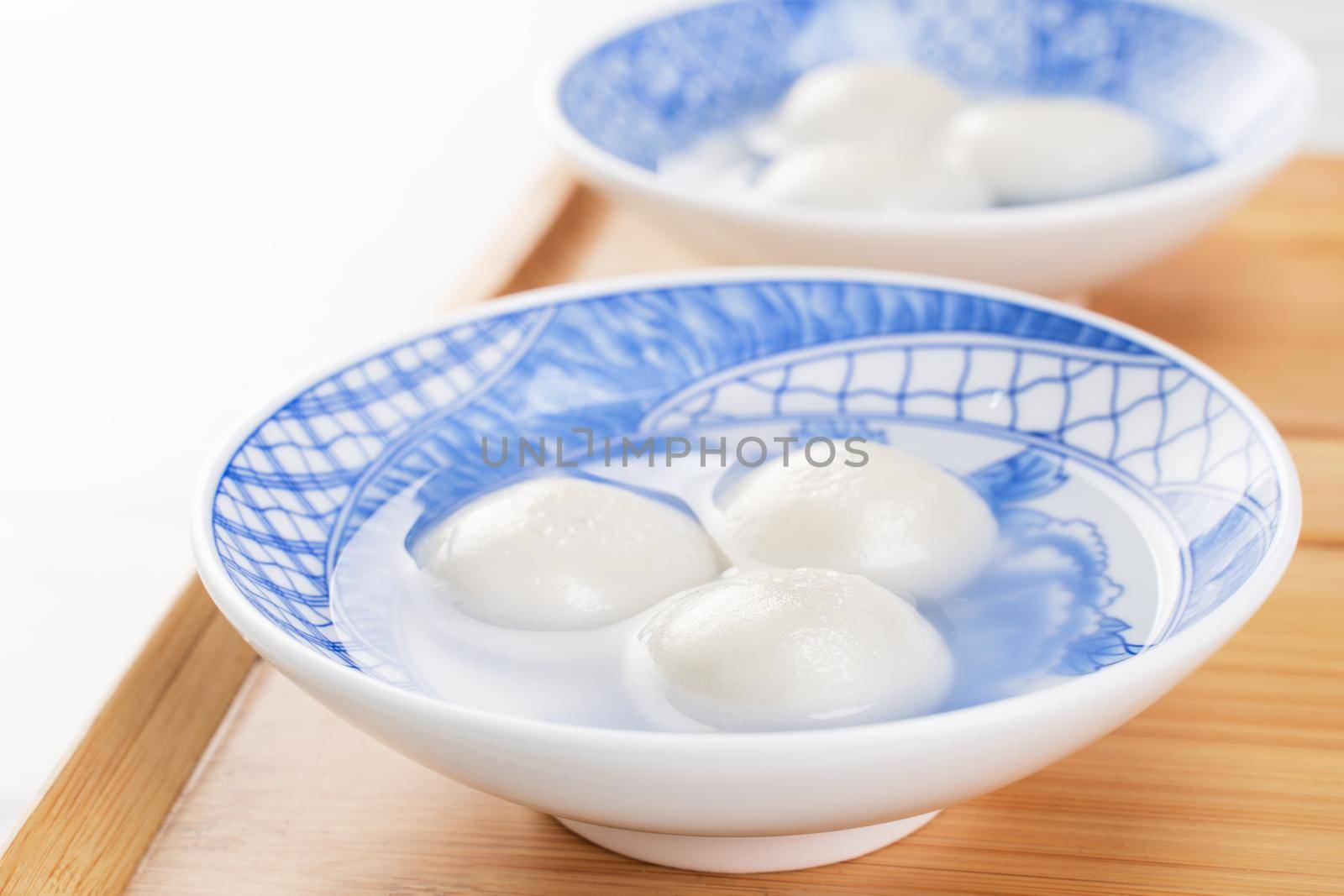Delicious tang yuan, yuanxiao in a small bowl. Asian traditional festive food rice dumplings ball with stuffed fillings for Chinese Lantern Festival, close up.