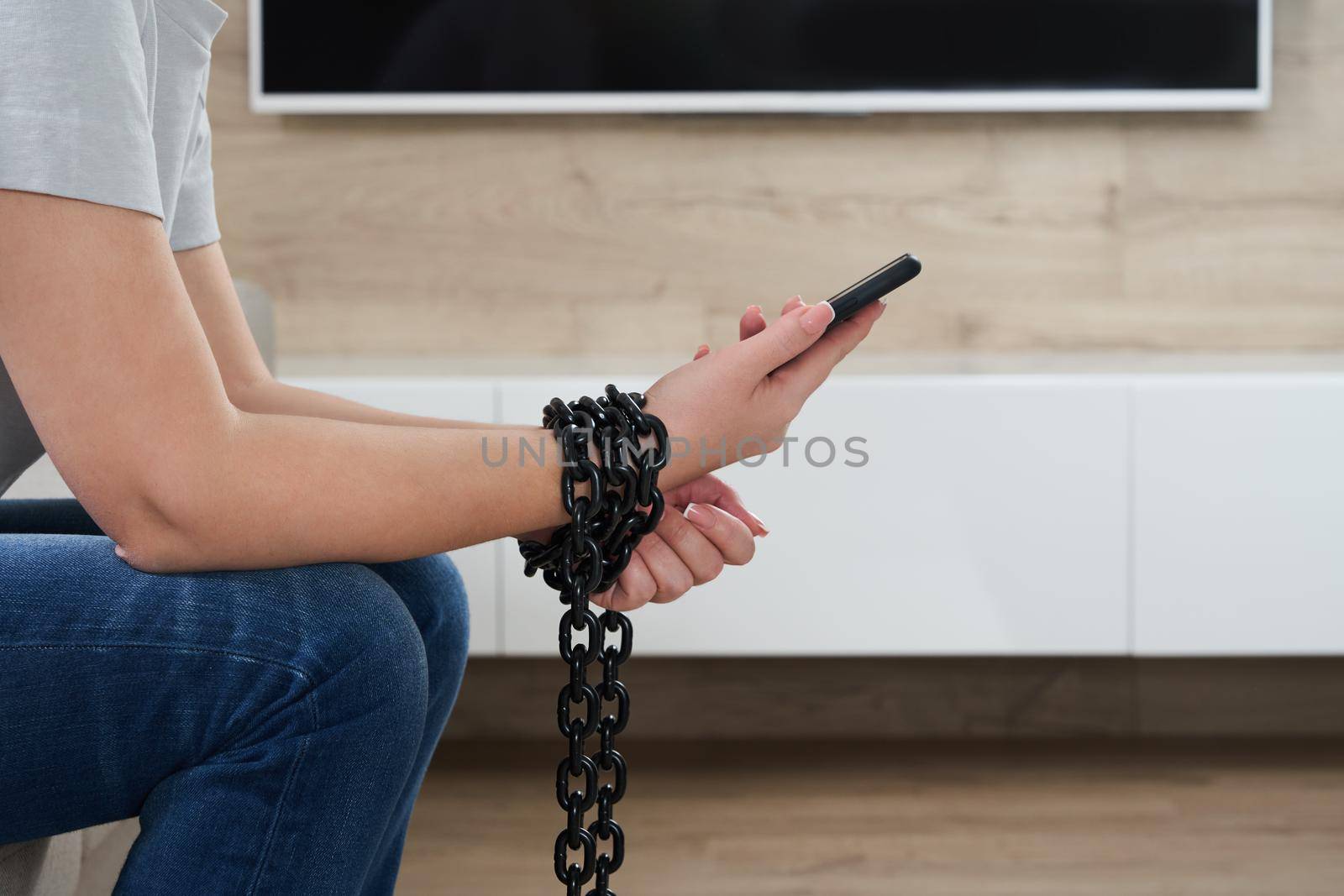 Close-Up Of Person Holding Mobile Phone And Chain