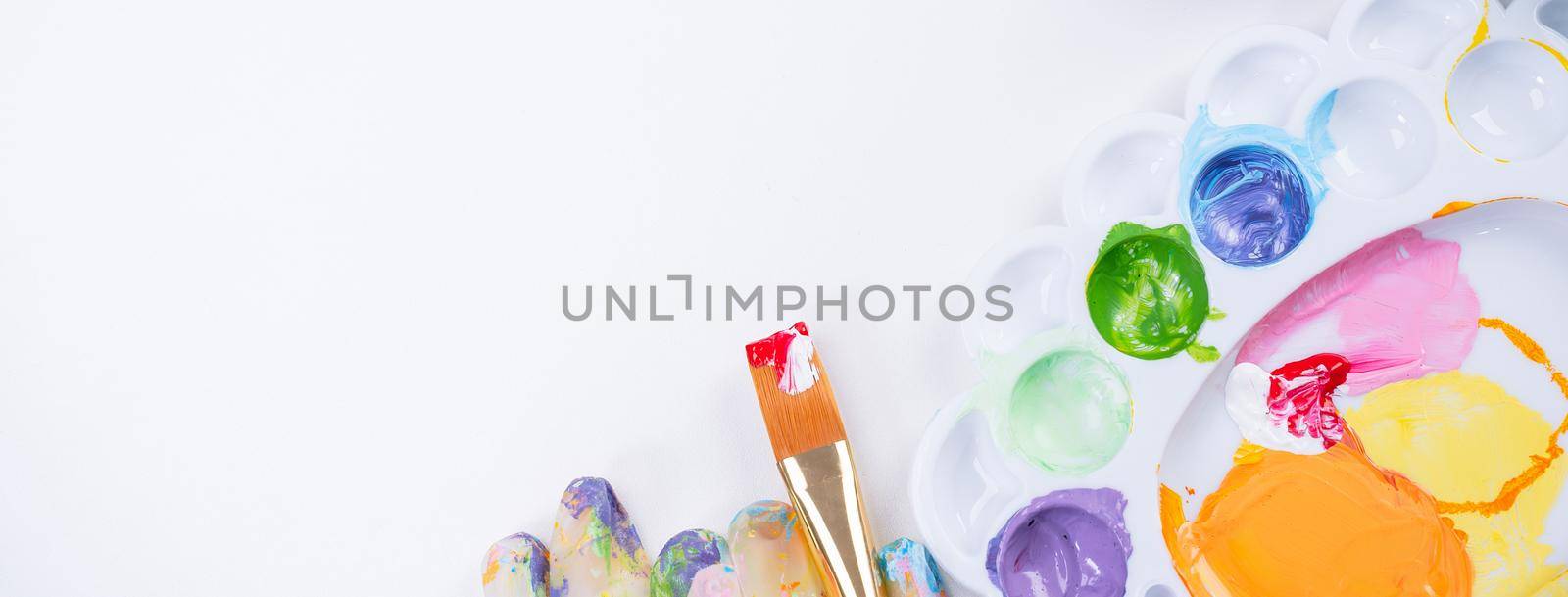 Design concept - Preparing for Easter celebration, painting Easter eggs with colorful Acrylic pigment color dyestuff in palette, top view, lifestyle.