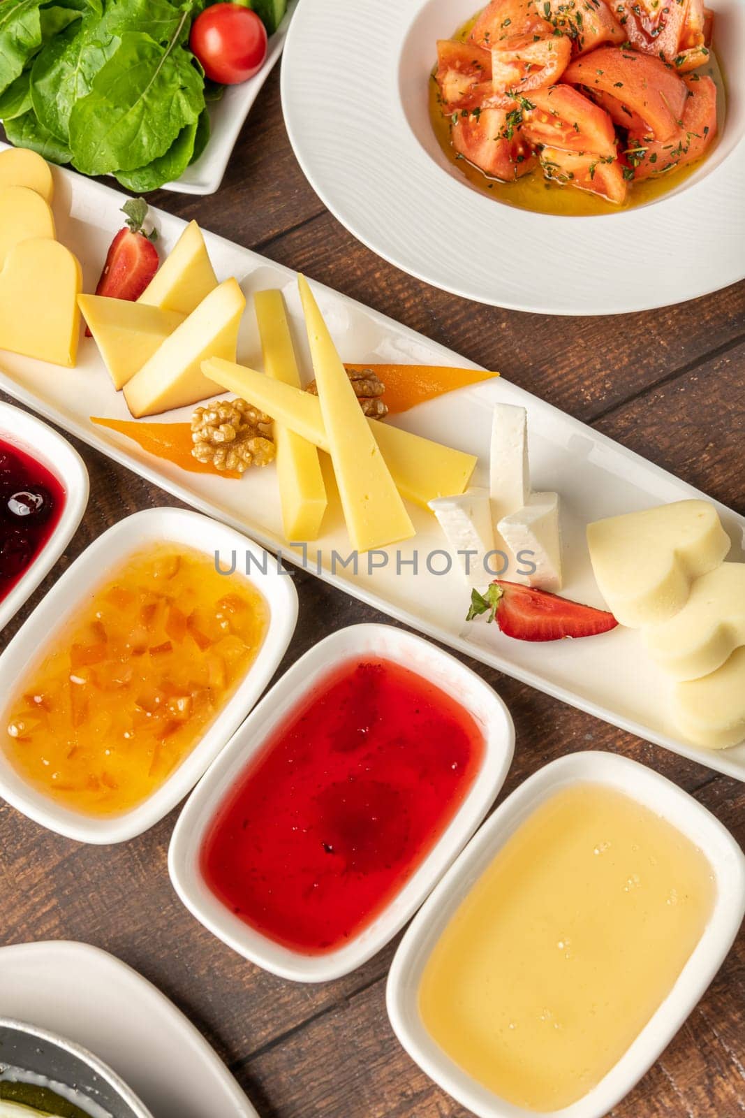 Traditional Turkish Breakfast served with traditional turkish tea on wooden table by Sonat