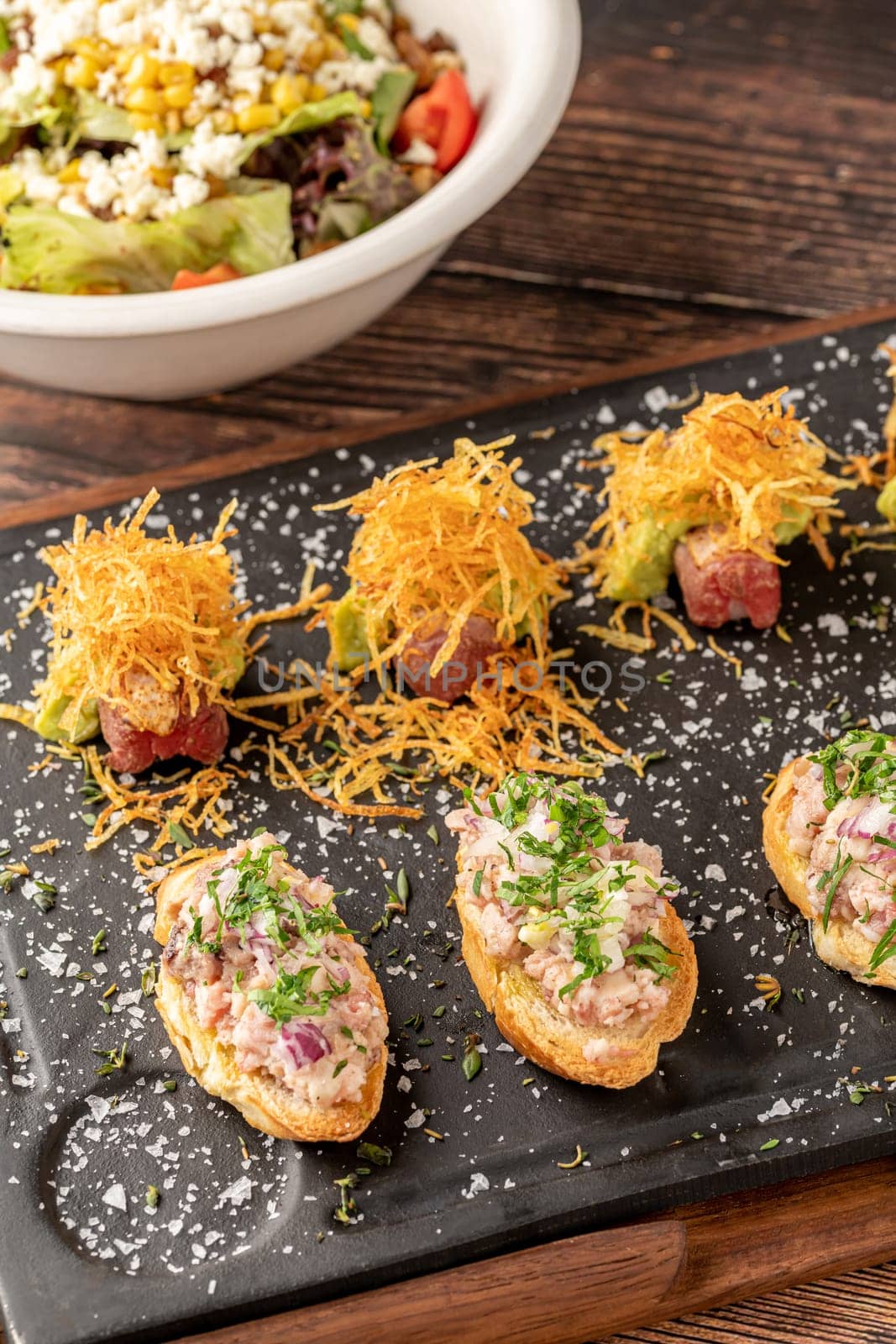 bruschetta with seafood made with Asian flavors on a stone cutting board