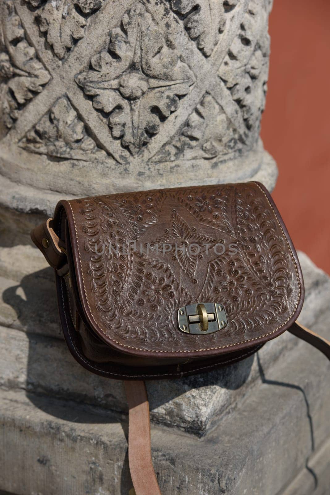 small brown leather bag with a carved pattern. by Ashtray25