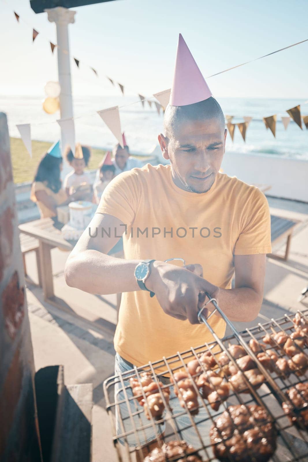 Family barbecue, meat and man at a party, cooking food and picnic on a holiday. Summer, hungry and a father with bbq on the grill for woman and children on vacation for a birthday celebration.