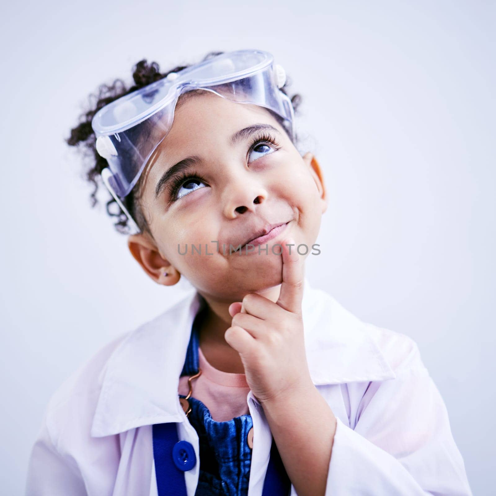 Child, thinking and face of scientist girl in studio with .hand on chin, goggles and idea. Happy African kid student with solution or problem solving medical science, education or biology experiment by YuriArcurs