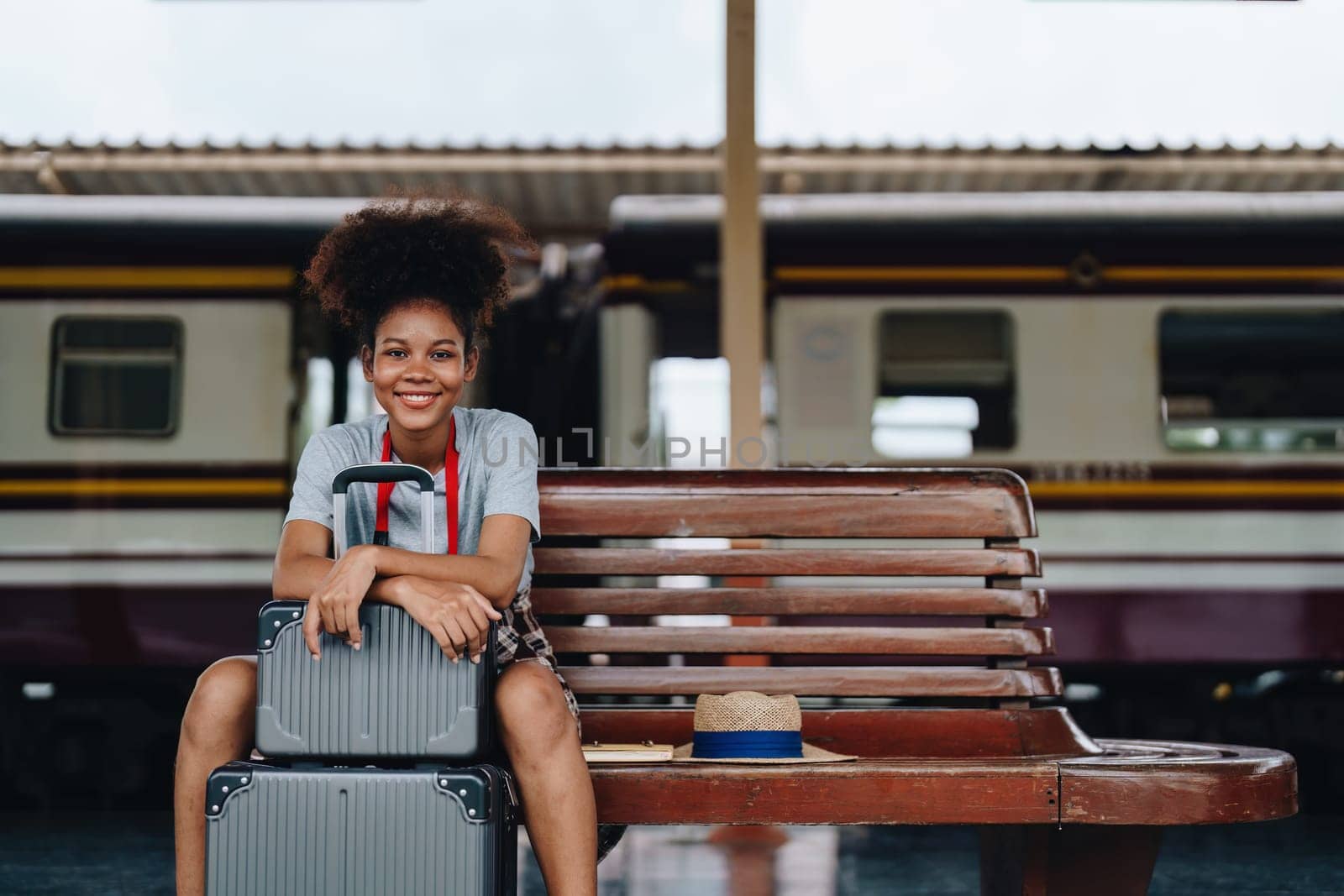 Tourists african american are showing happy expressions while waiting for their journey in the train station