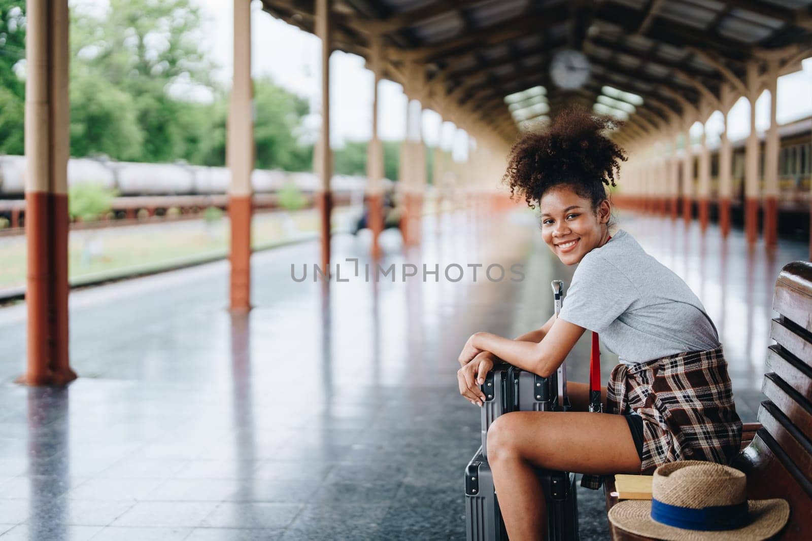 Tourists african american are showing happy expressions while waiting for their journey in the train station