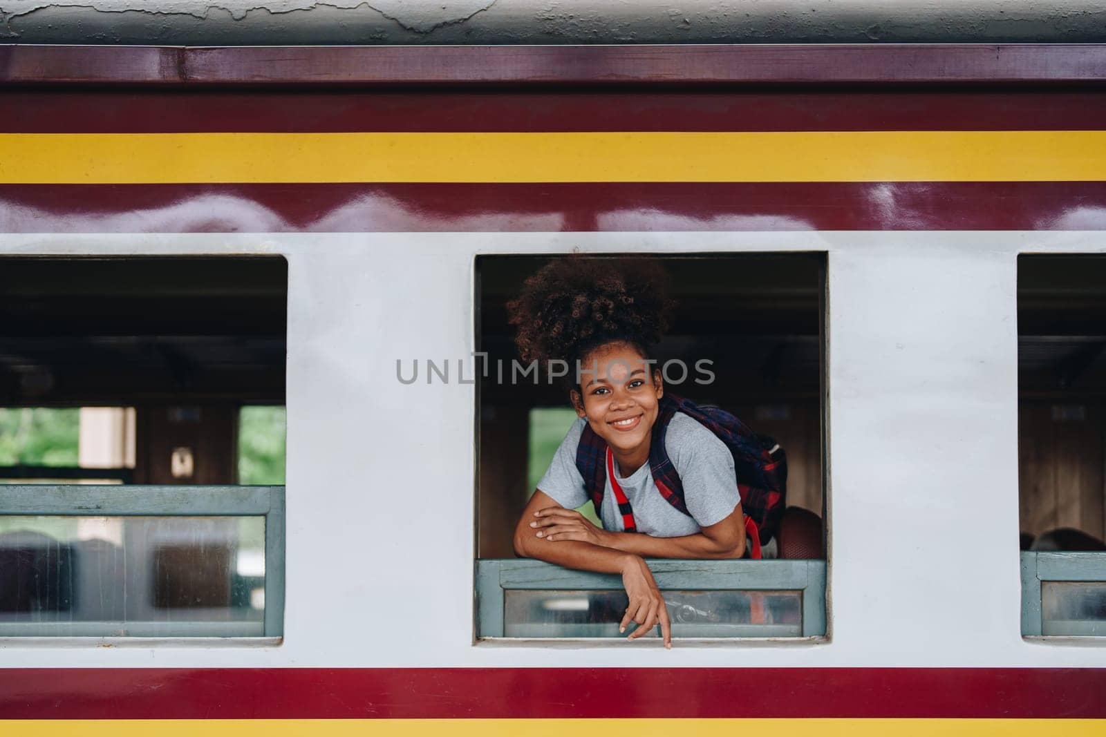 Tourists african american are showing happy expressions while waiting for their journey in the train station