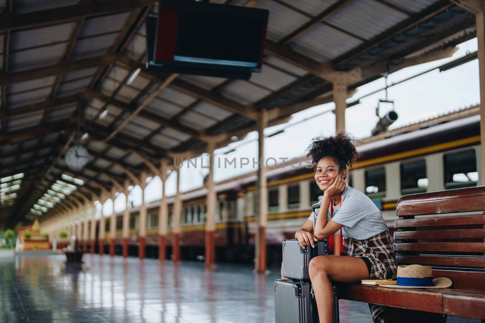 Tourists african american are showing happy expressions while waiting for their journey in the train station