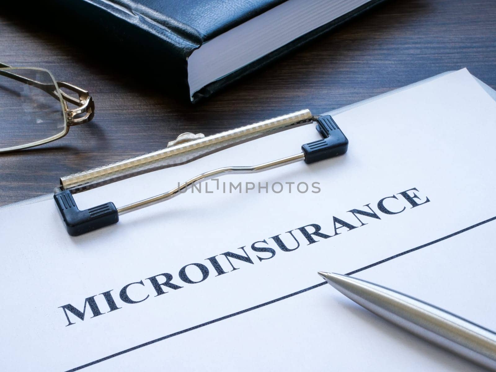 Clipboard with microinsurance application and notepad.