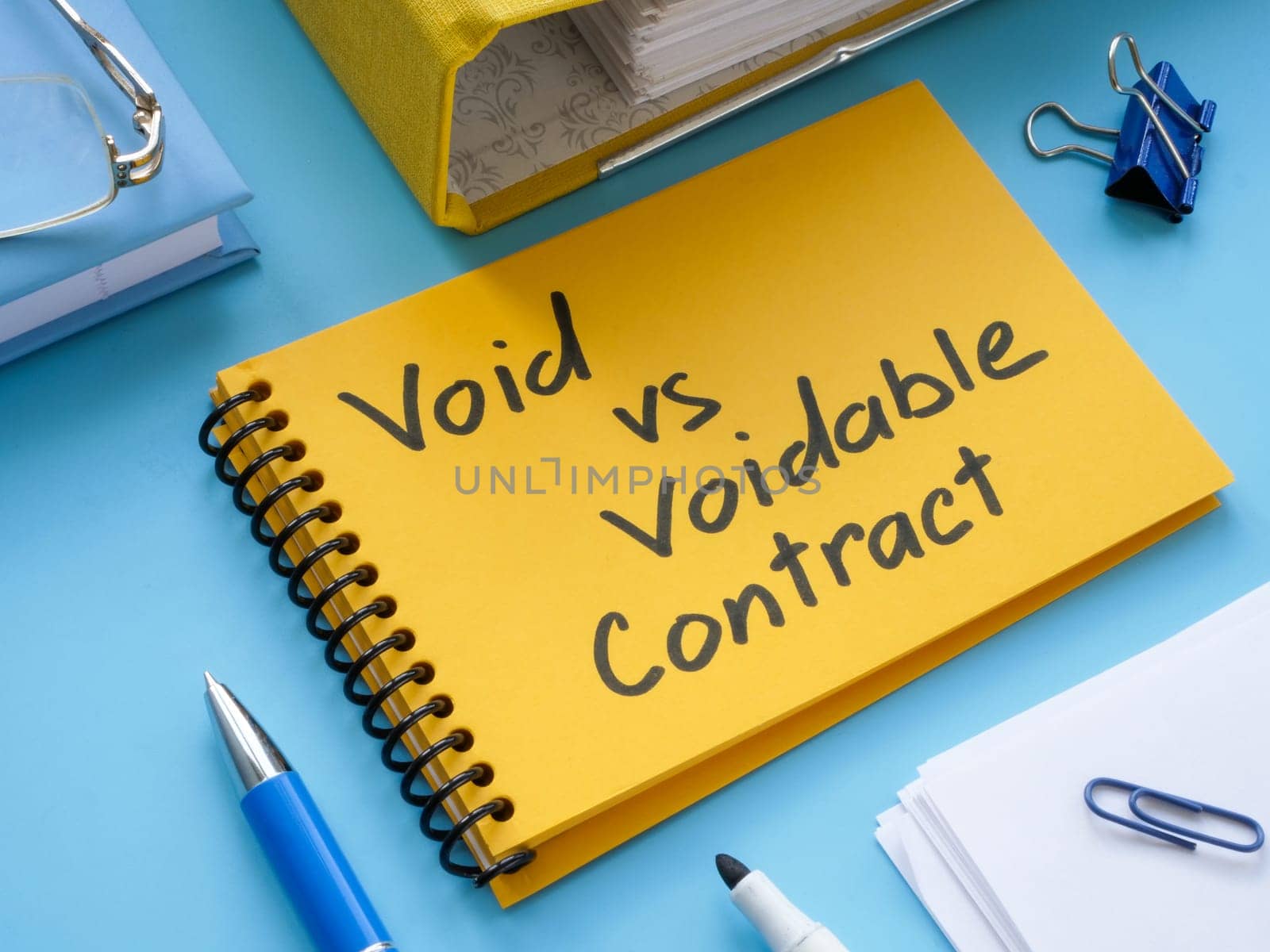 Yellow notepad with inscription void vs voidable contract. by designer491