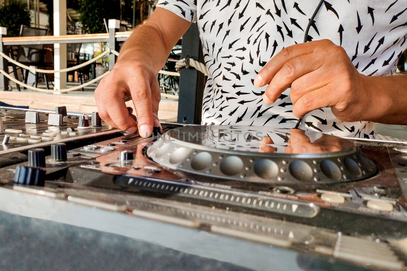Turkey, Alanya - August 12, 2022: DJ's hands on mixing player close-up, on beach