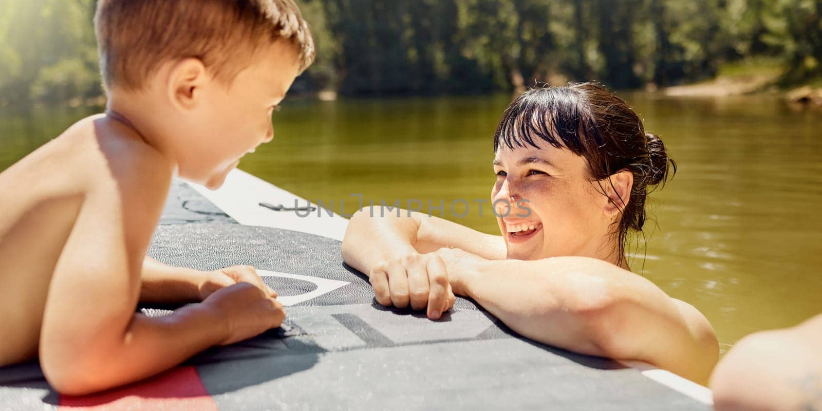 Happy, mother with child and with boat in lake together with smile for bonding time. Summer vacation or holiday break, canoe or freedom and people in a river with outdoor activity for adventure by YuriArcurs