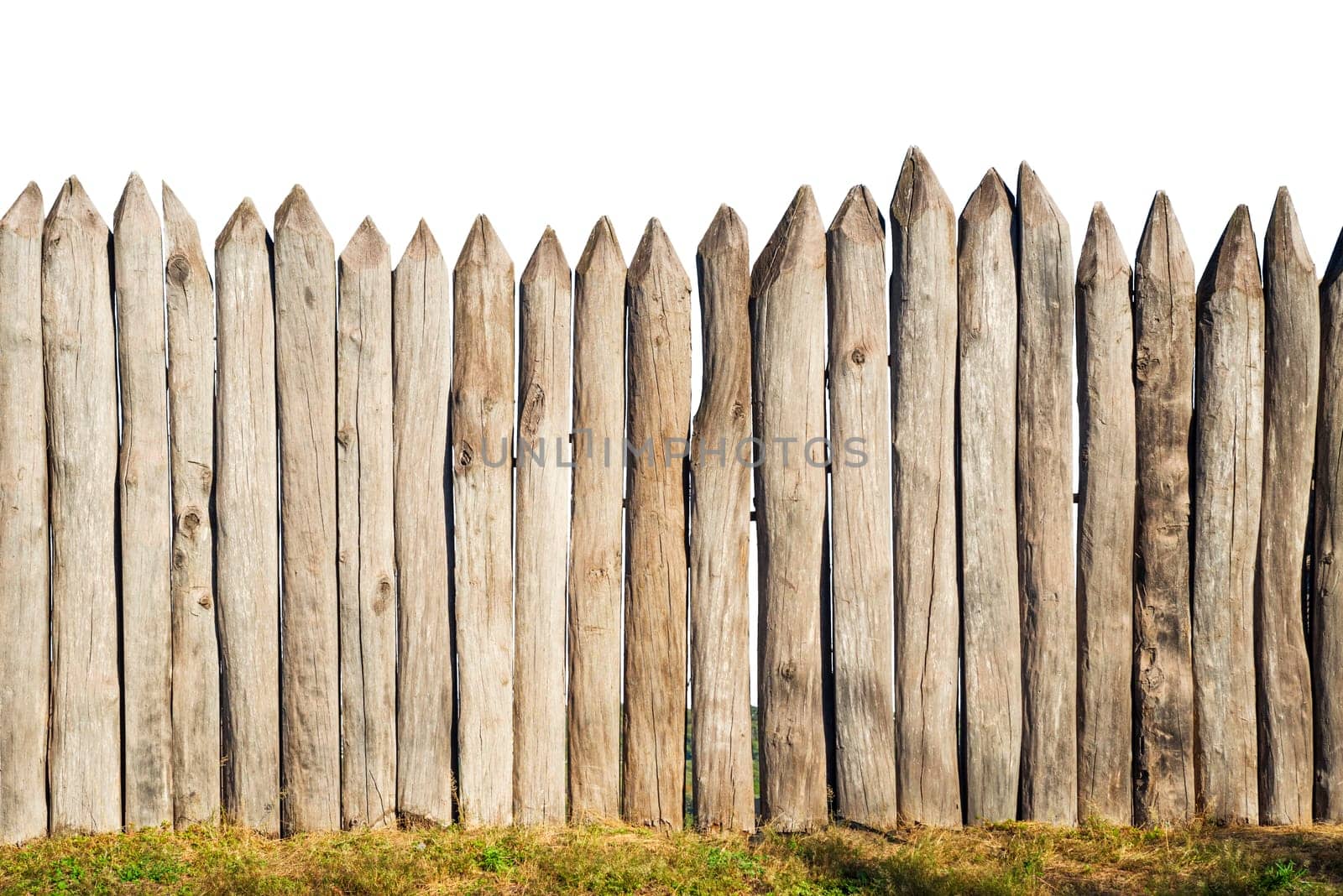 Wooden fence from logs isolated on white background. Fence from a stockade fence on white.