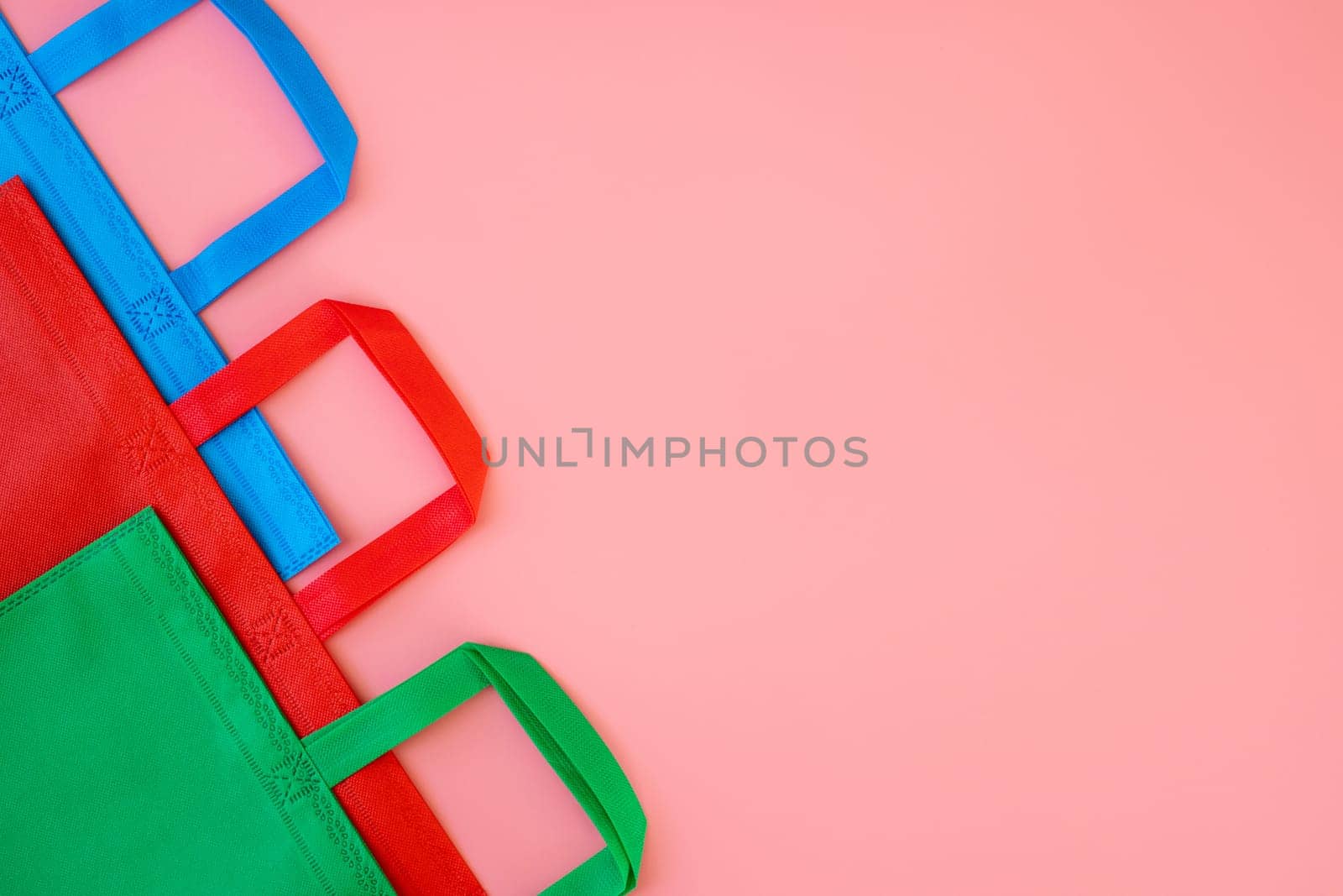 Colorful shopping bags on pink background. Mockup for design. Shopping and sale concept.